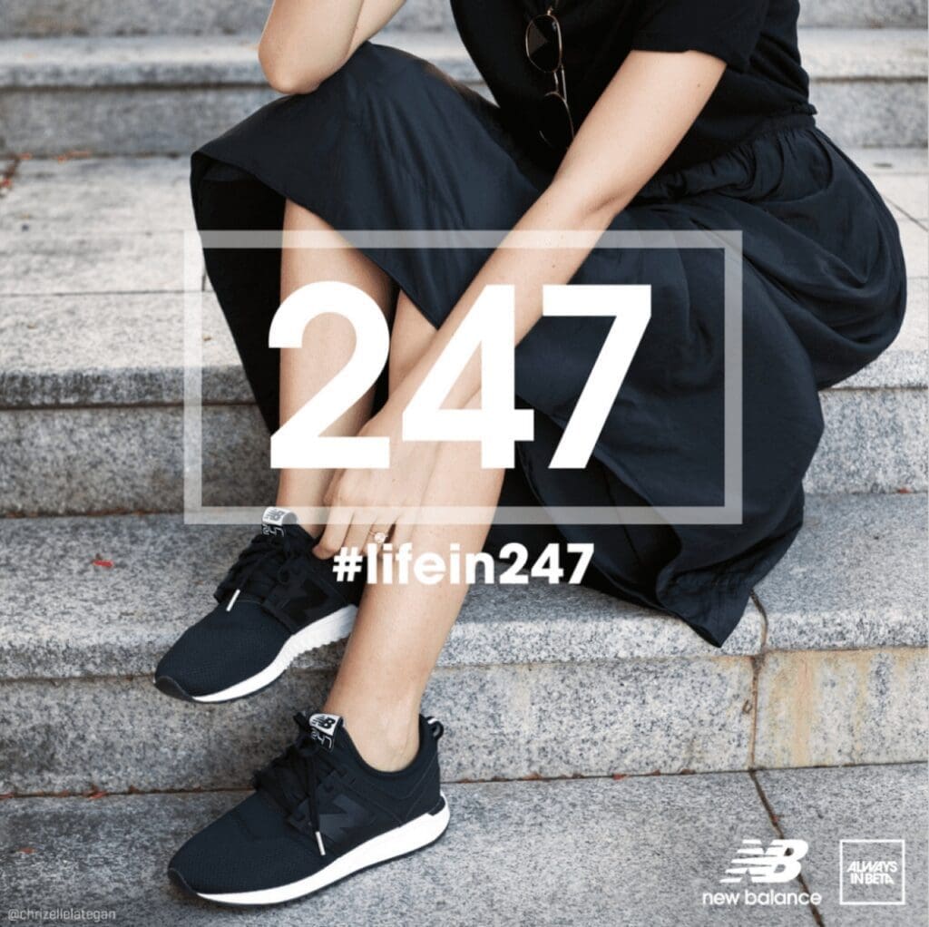 woman wearing black dress and black nb trainers