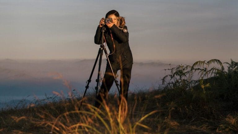 woman using camera on tripod
