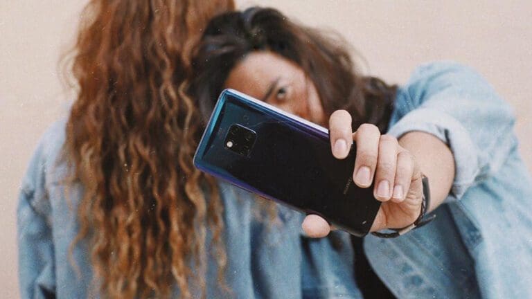 man holding phone to camera
