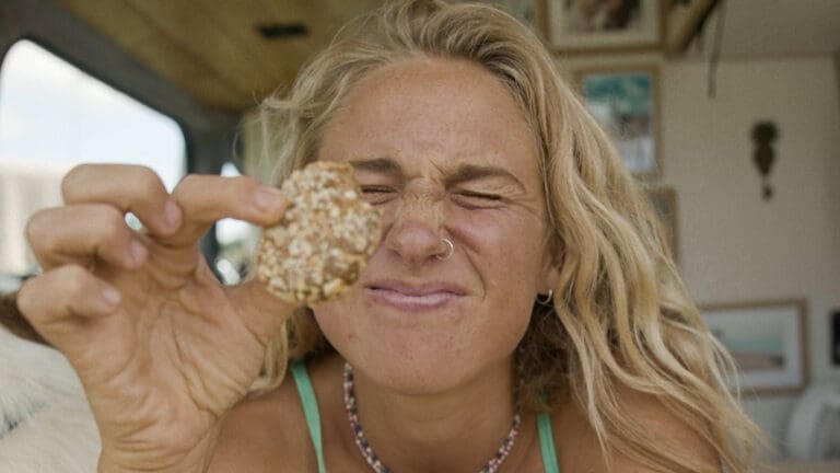 woman holding biscuit to camera