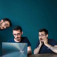 man on laptop with teal colours